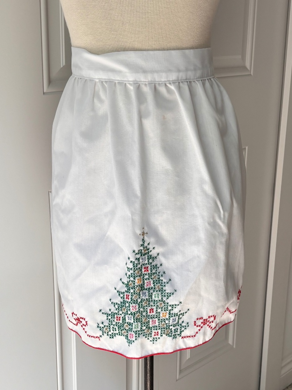 Vintage white half apron featuring hand-stitched cross-stitch Christmas trees